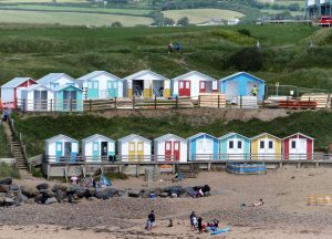 Brightly coloured beach huts overlooking Summerleaze Beach in Bude