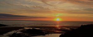 The sun sets into the Atlantic Ocean as seen from Bude, Cornwall